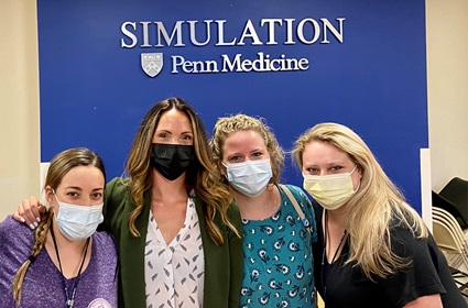four people smiling